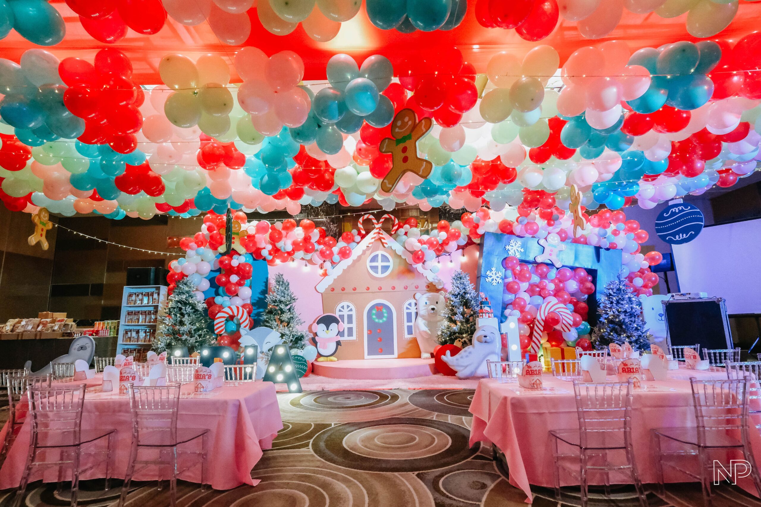 Christmas themed kids' party decor with colorful decorations, festive lights, and playful holiday elements. Expert event styling in Metro Manila, Philippines, featuring Christmas trees, Santa Claus, reindeer, and fun holiday-themed activities. Perfect for children's birthday parties, family gatherings, and festive kids' events.