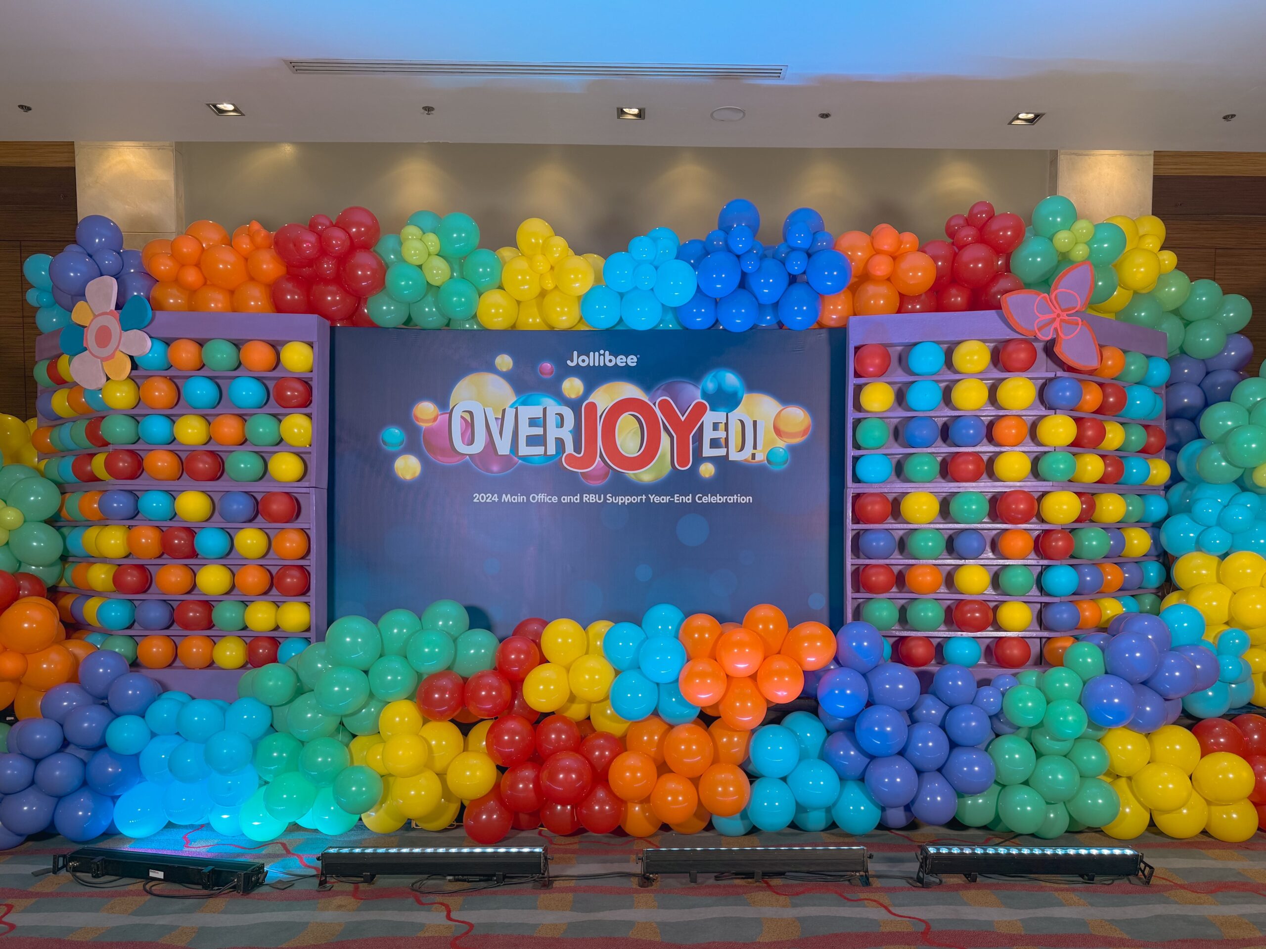 Corporate event styling by professional event stylist for Jollibee – elegant stage design, branded corporate setup, balloon arrangements and custom decor, trusted event coordinator for company events in Metro Manila