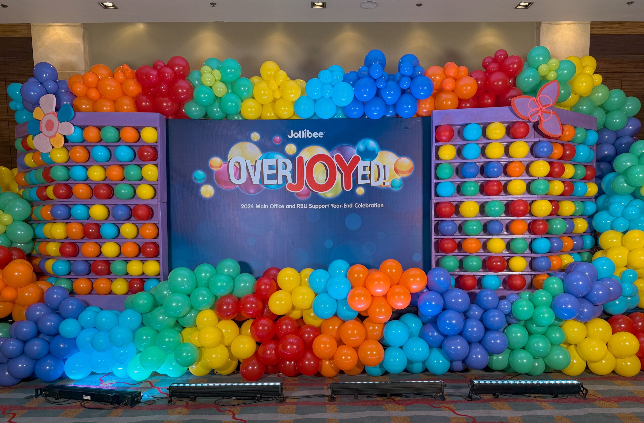 Corporate event styling by professional event stylist for Jollibee – elegant stage design, branded corporate setup, balloon arrangements and custom decor, trusted event stylist for company events in Metro Manila Philippines