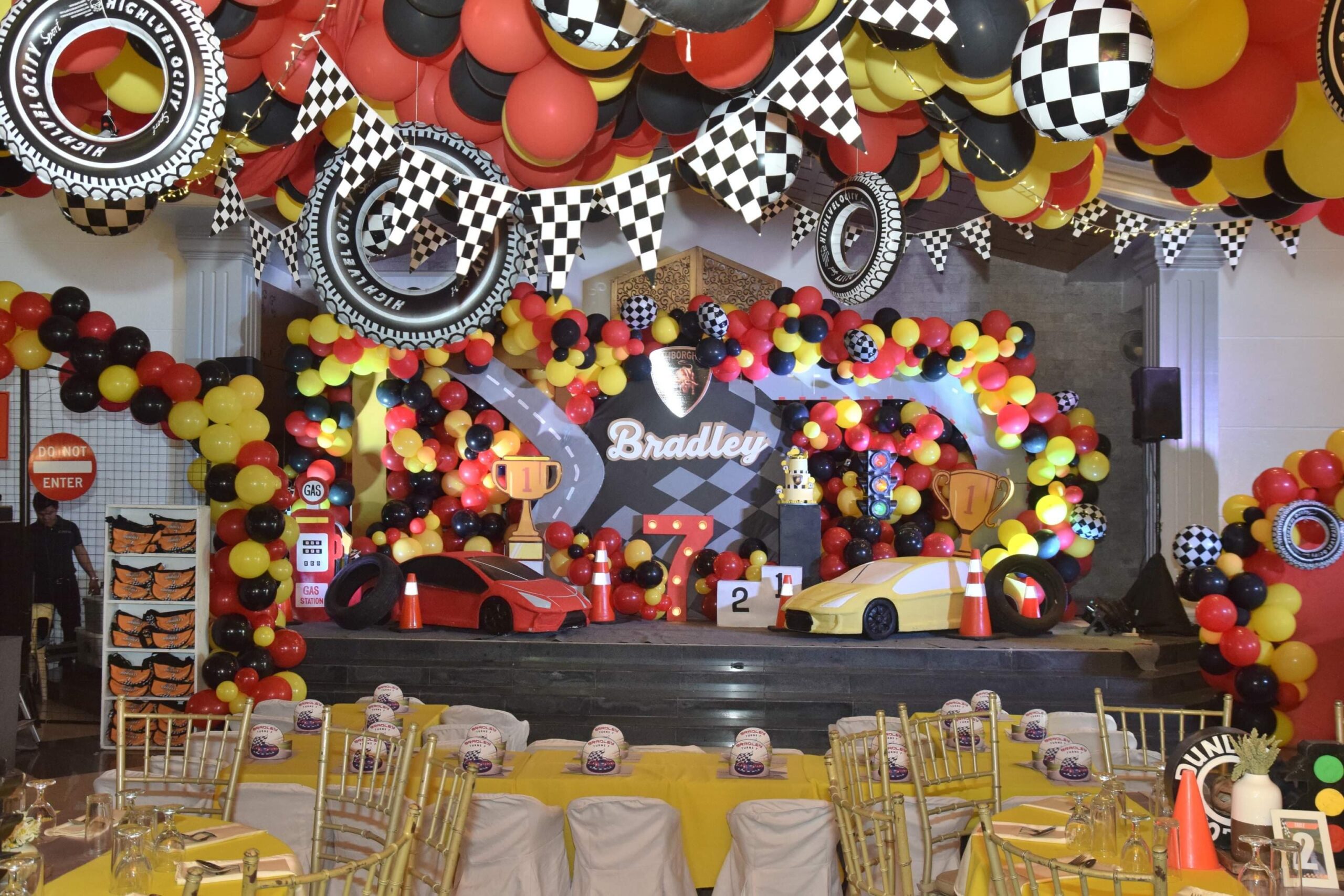 Creative racing car-themed kiddie party setup in the Philippines with race track elements, checkered flags, and vibrant car decor