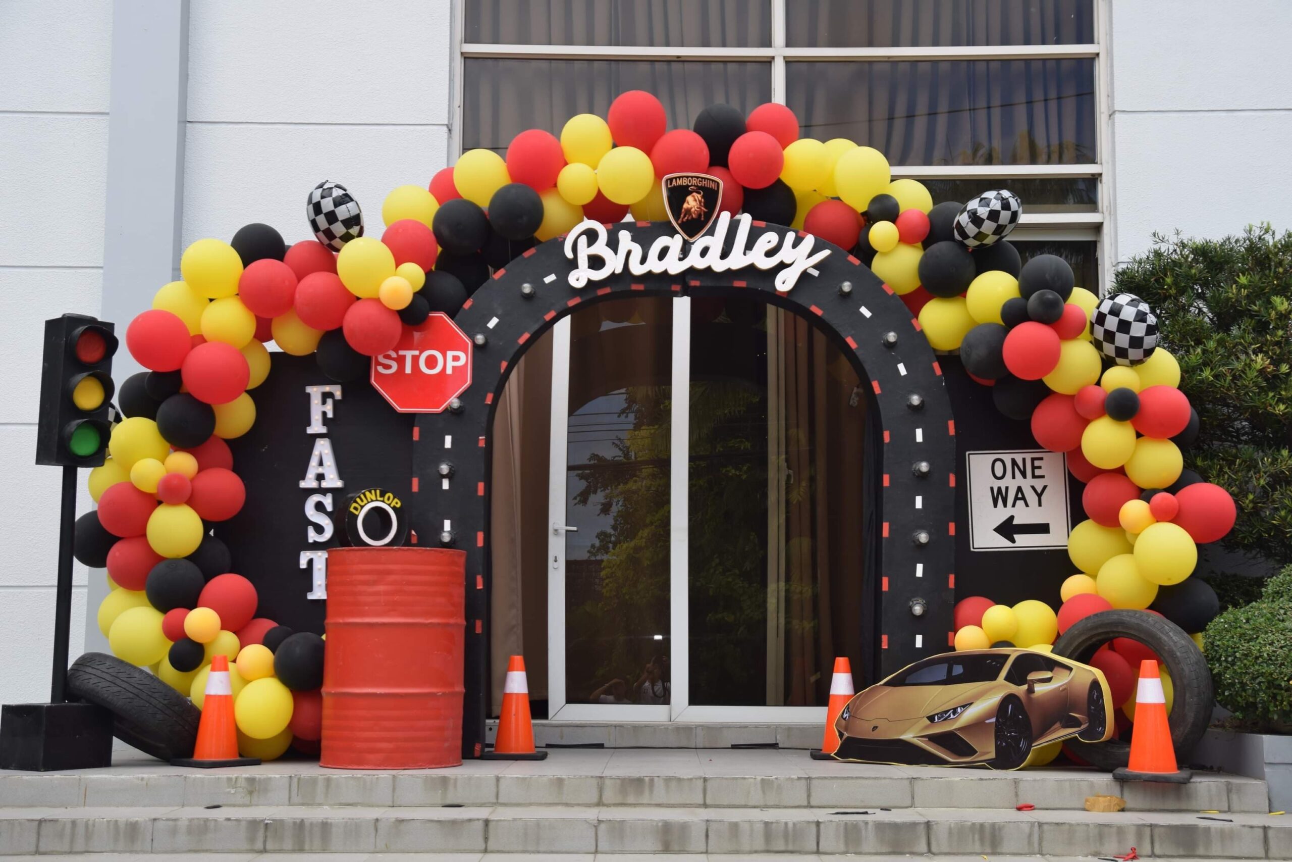Creative racing car-themed kiddie party setup in the Philippines with race track elements, checkered flags, and vibrant car decor