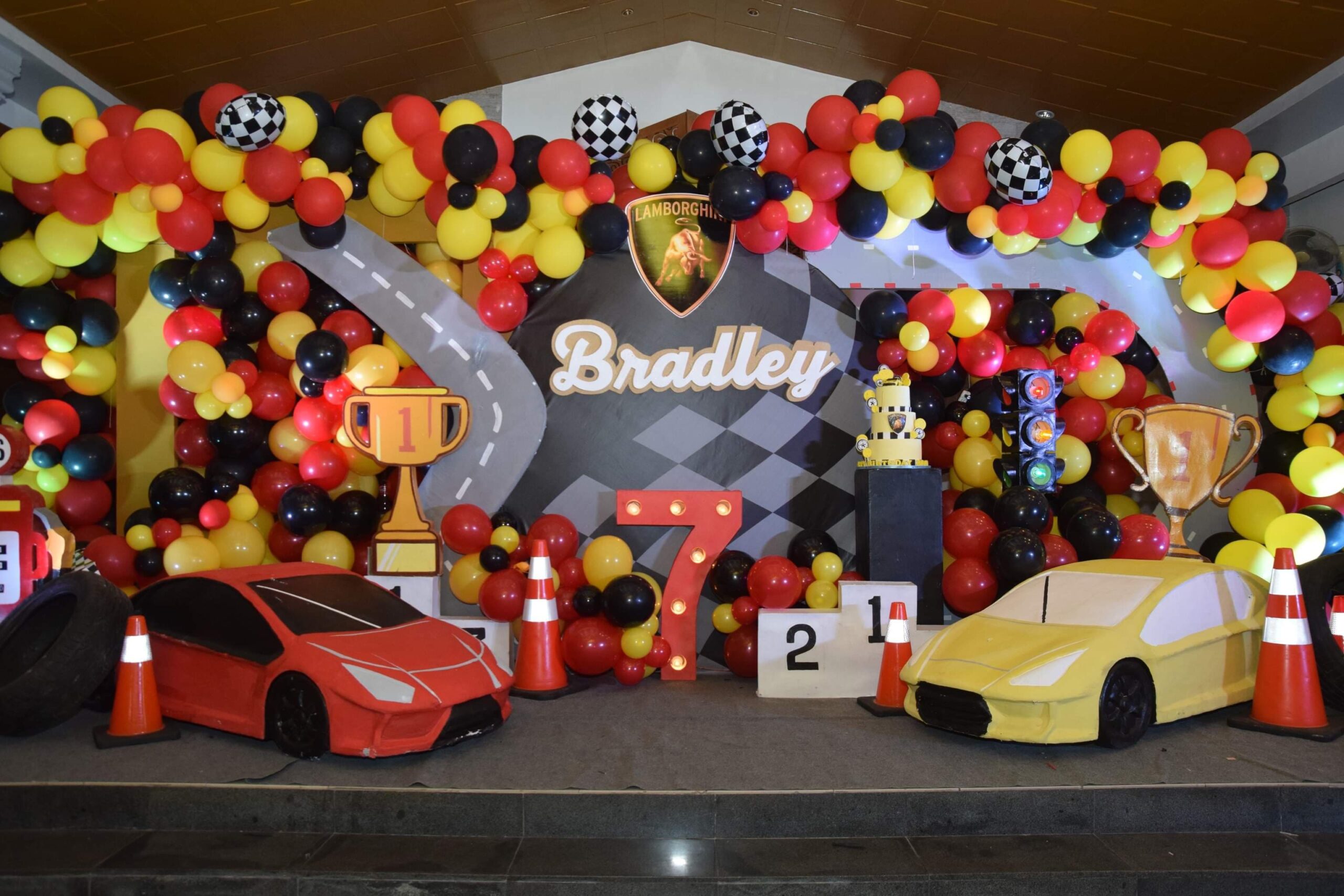 Creative racing car-themed kiddie party setup in the Philippines with race track elements, checkered flags, and vibrant car decor