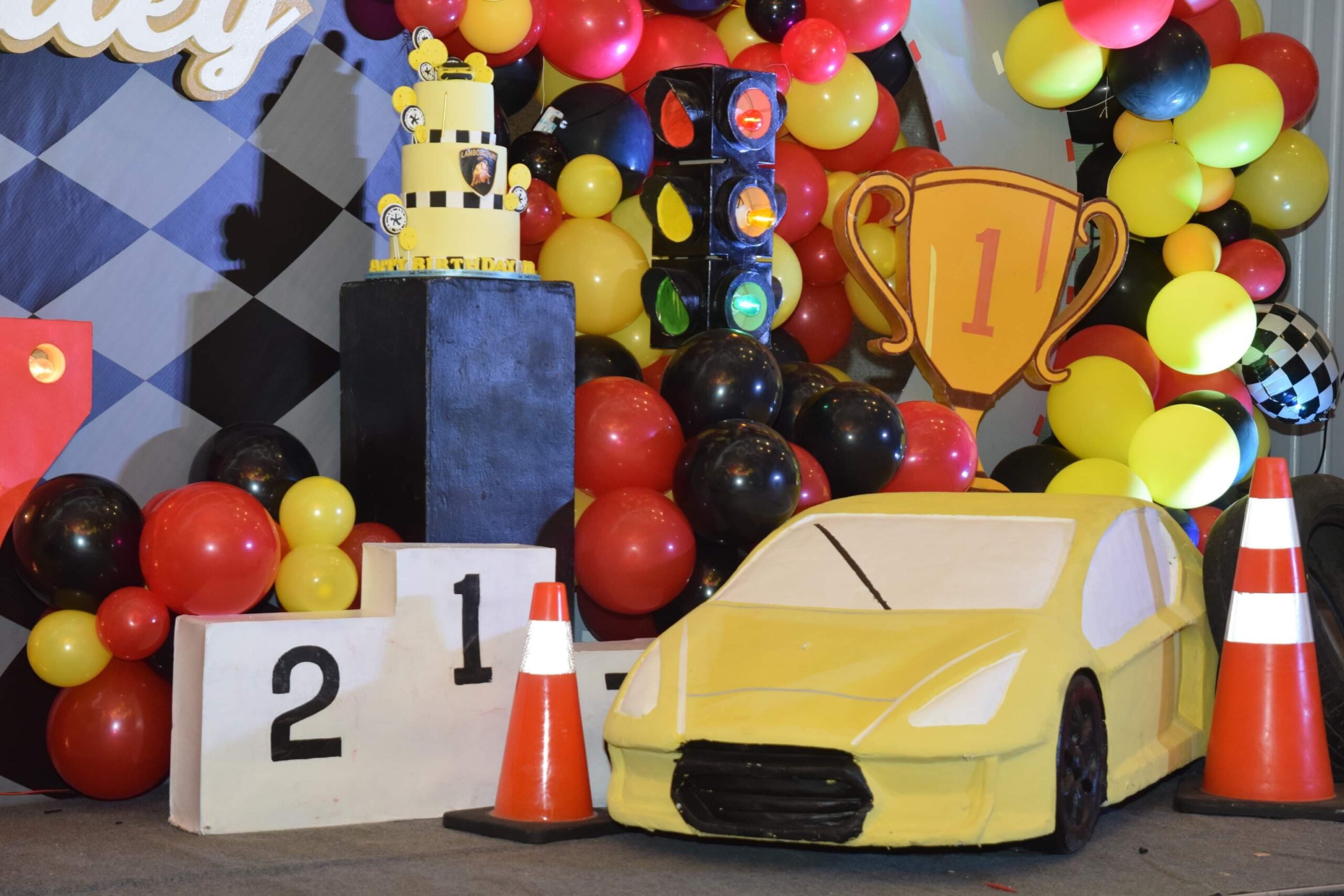 Creative racing car-themed kiddie party setup in the Philippines with race track elements, checkered flags, and vibrant car decor