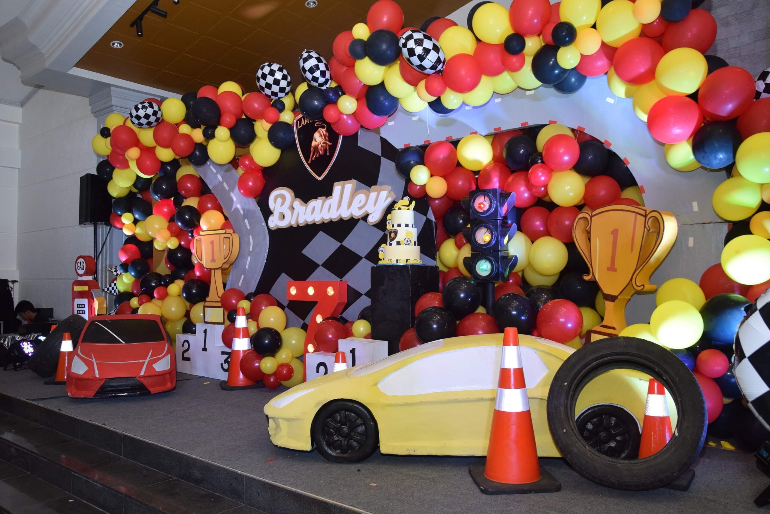 Creative racing car-themed kiddie party setup in the Philippines with race track elements, checkered flags, and vibrant car decor