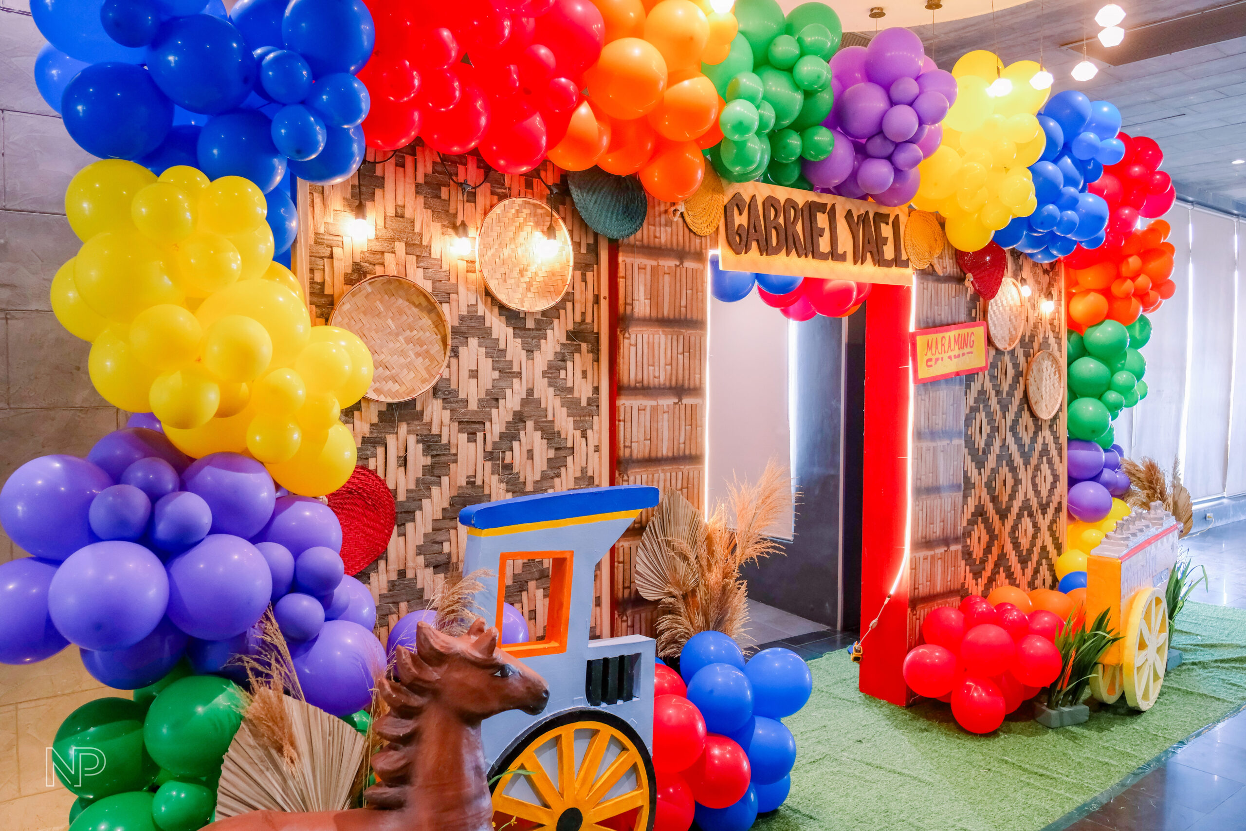 Creative Filipino-themed kiddie party setup featuring bamboo decorations, abaca accents, and colorful Filipino motifs"