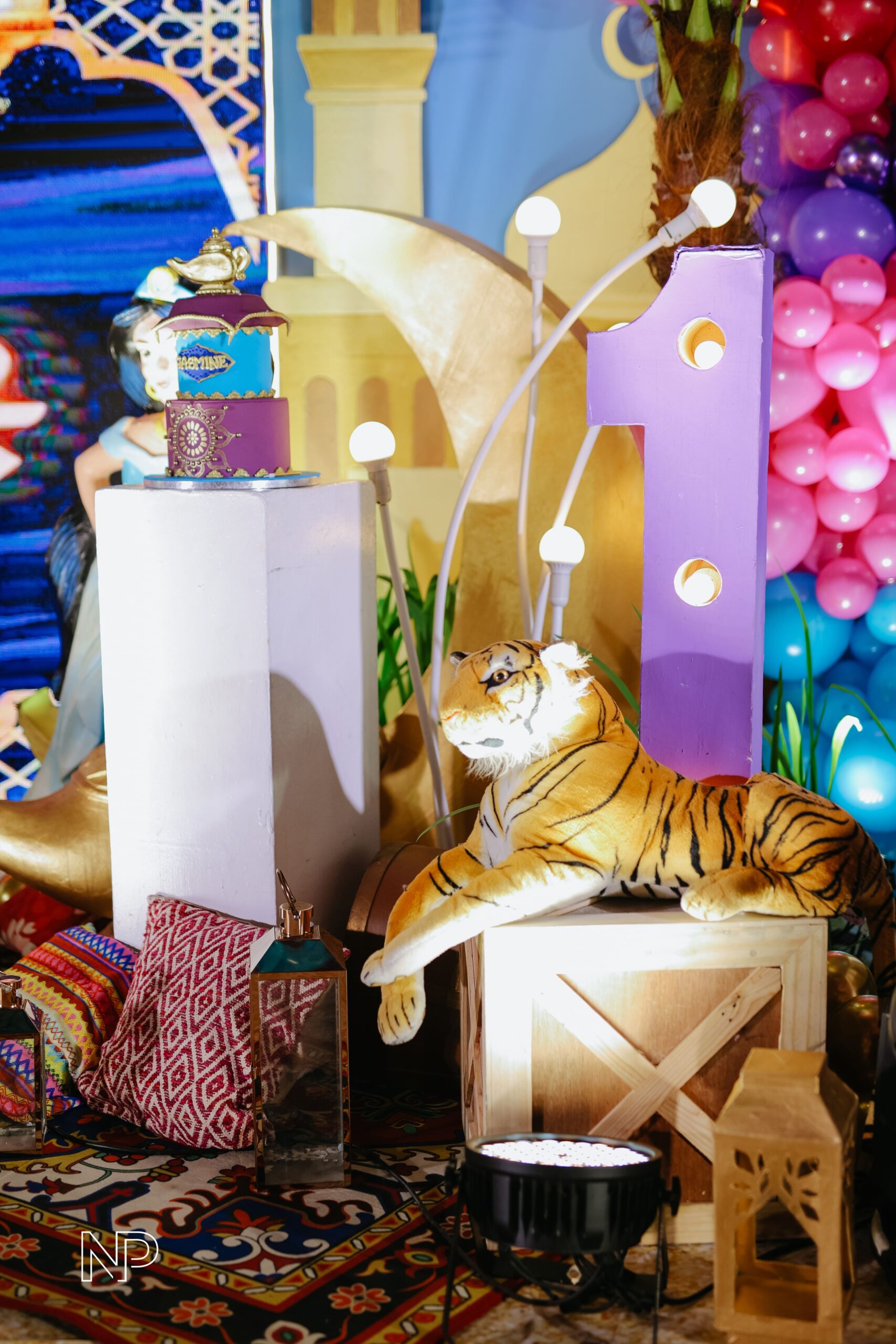 Aladdin themed event decor with magical Arabian Nights ambiance, vibrant colors, and intricate details. Event styling featuring Genie-inspired elements, lanterns, and Middle Eastern-inspired designs. Perfect for birthday parties, themed events, and fairytale celebrations