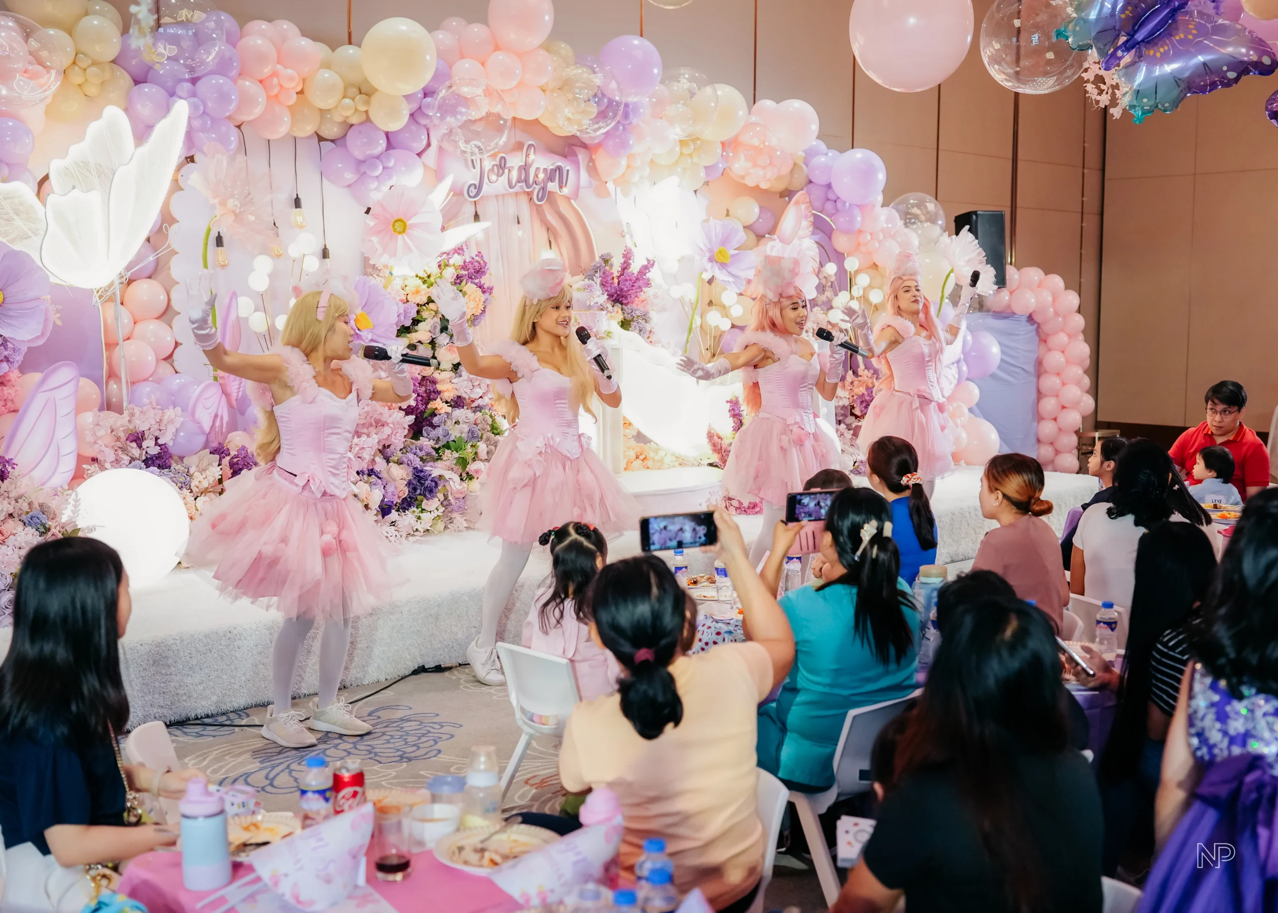 Pastel butterfly themed birthday party with pink and purple floral decorations