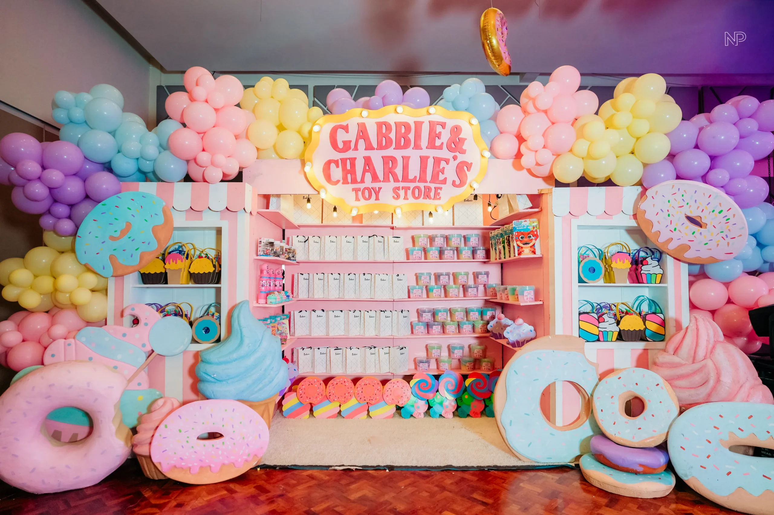 Pastel candy themed birthday party with donuts, lollipops and ice cream decorations