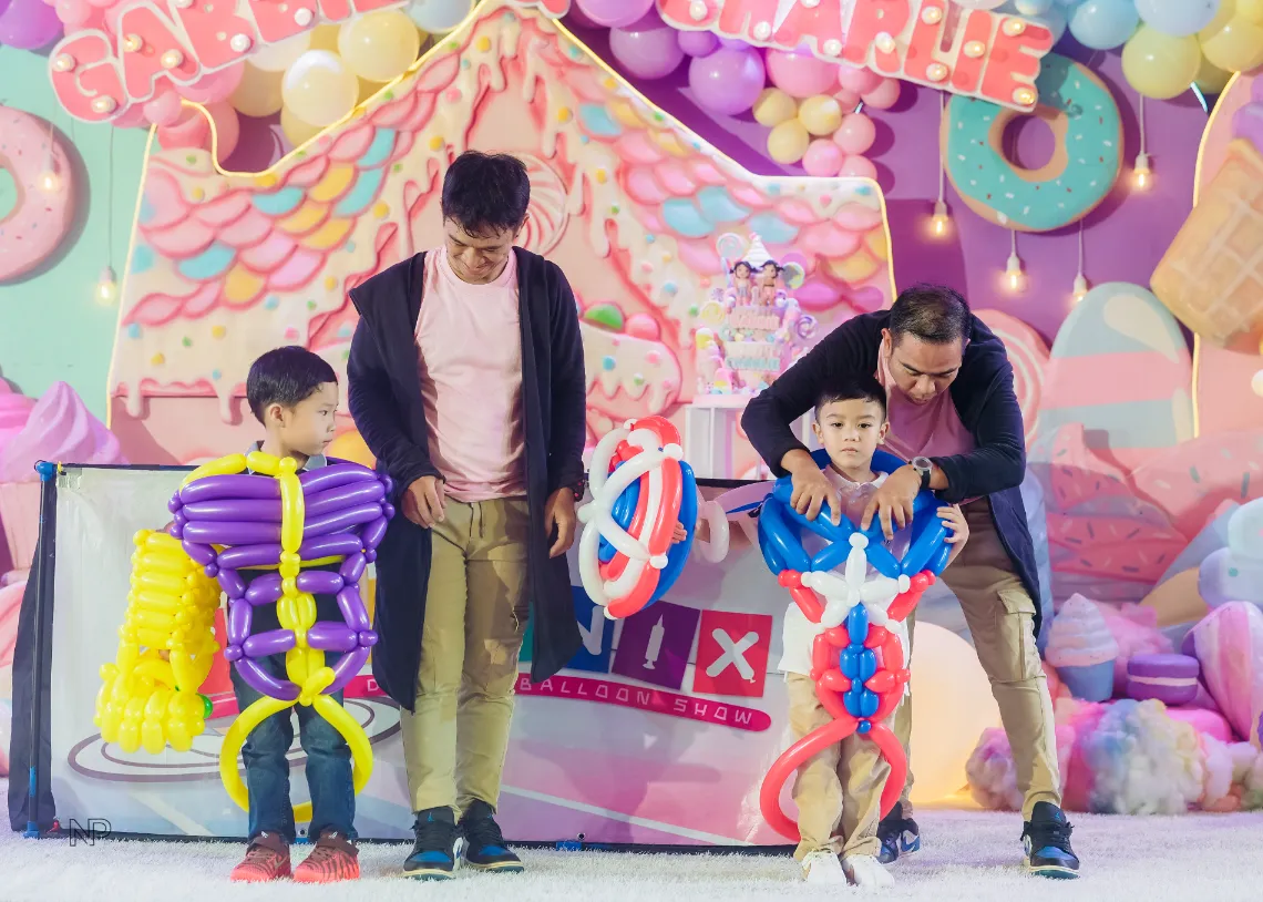 Kids Candyland birthday party with colorful balloons and sweet shoppe styling