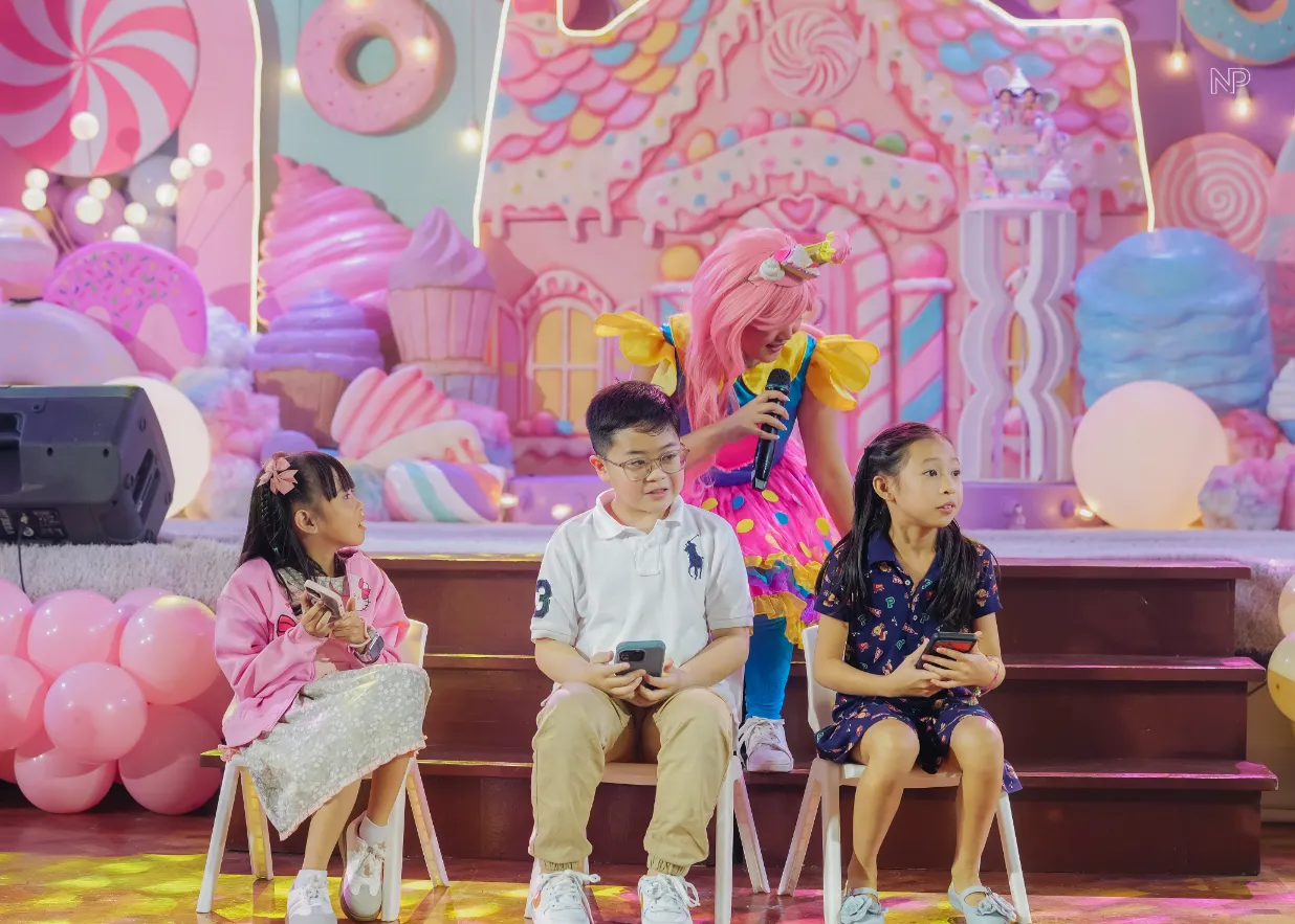 Kids Candyland birthday party with colorful balloons and sweet shoppe styling