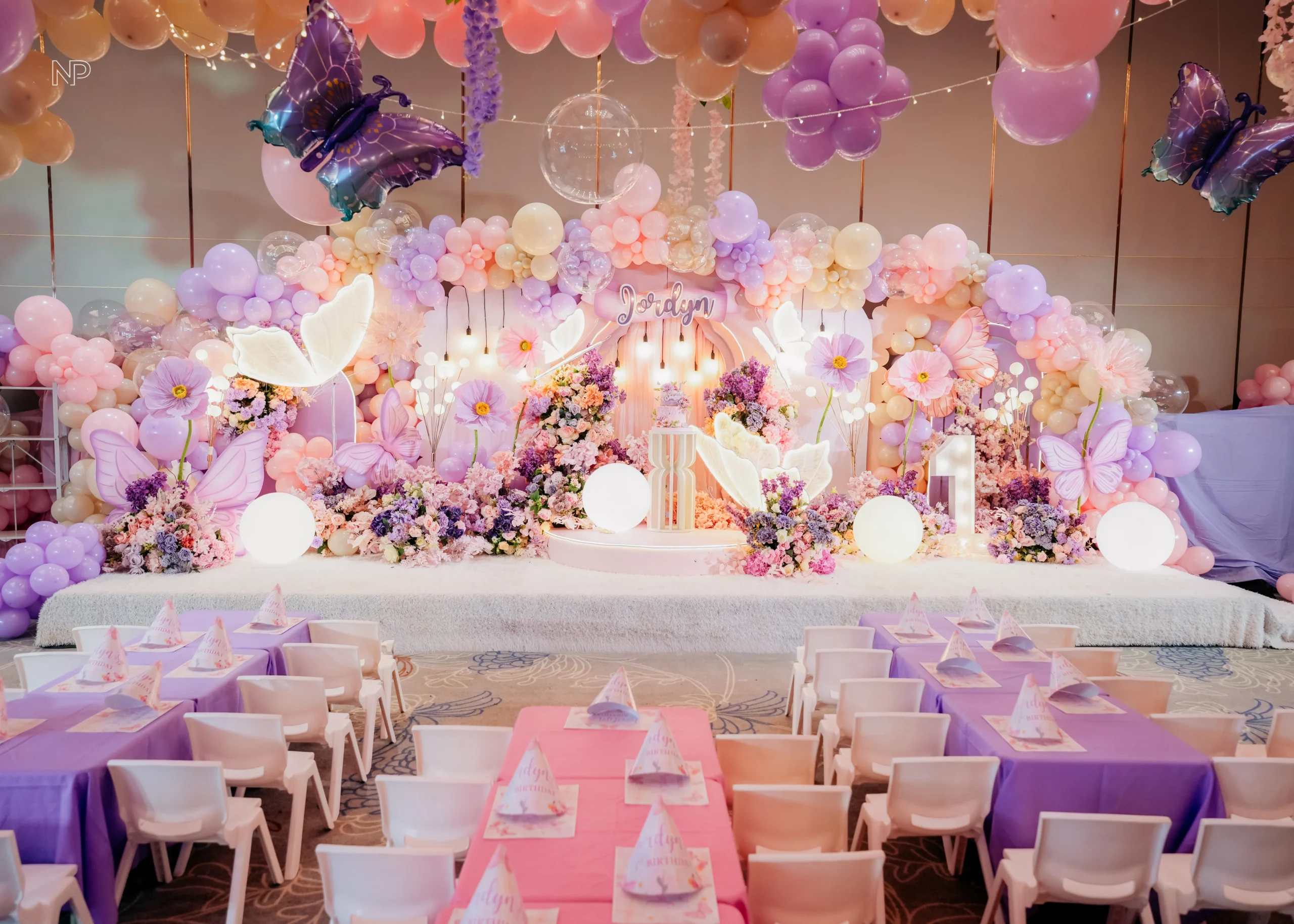 Pastel butterfly themed birthday party with pink and purple floral decorations