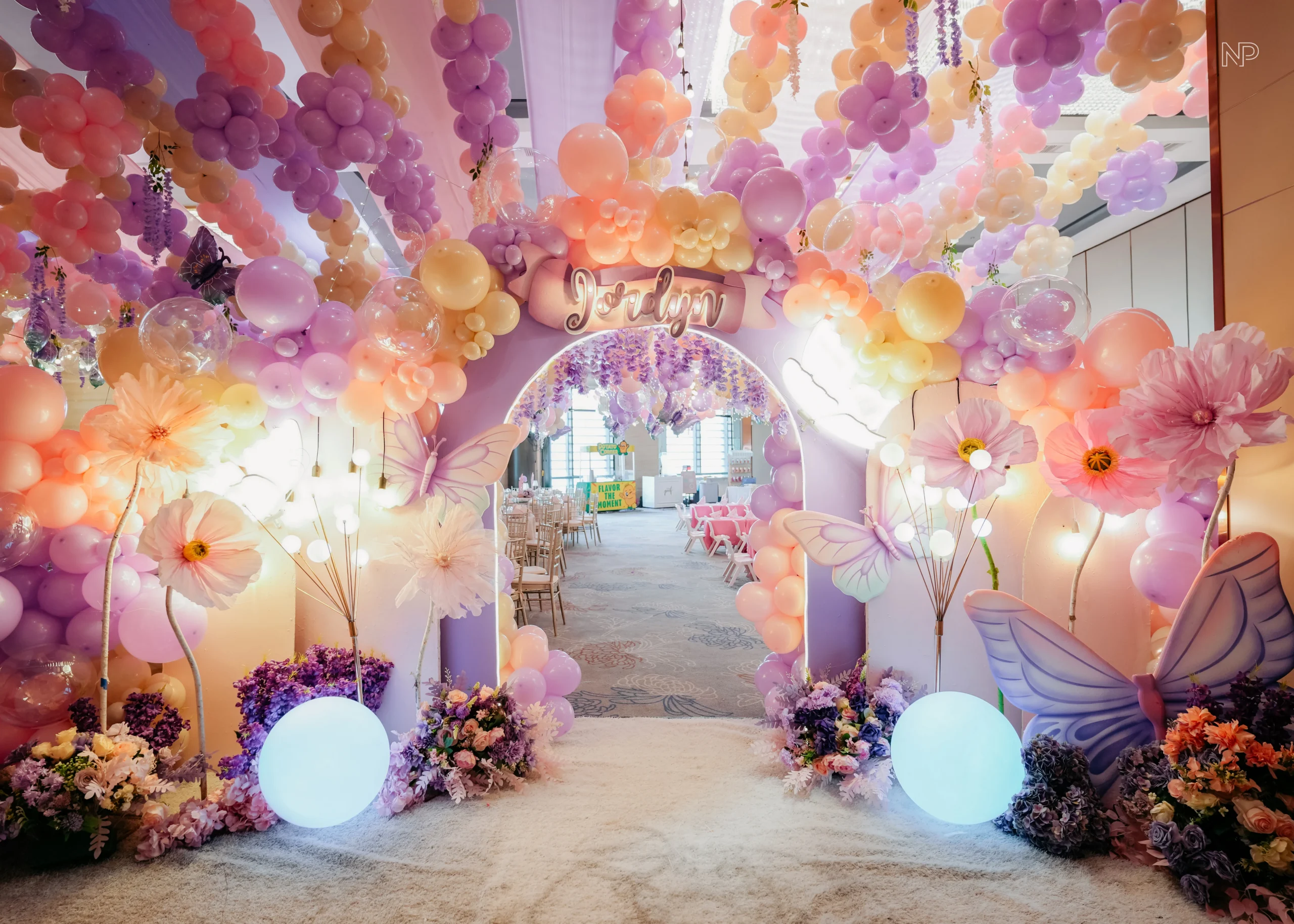 Pastel butterfly themed birthday party with pink and purple floral decorations