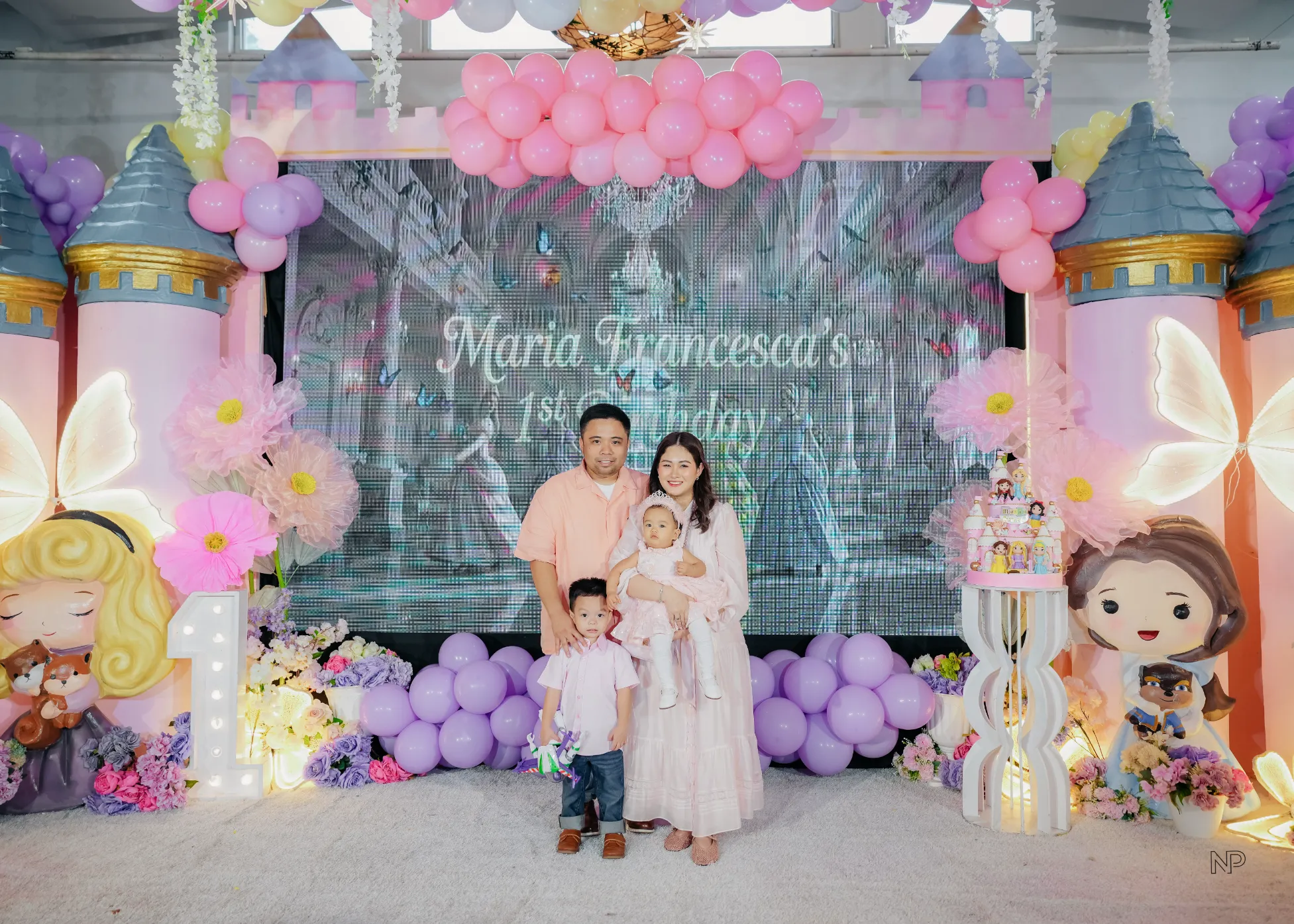 Princess birthday celebration with castle backdrop and pastel balloon decor