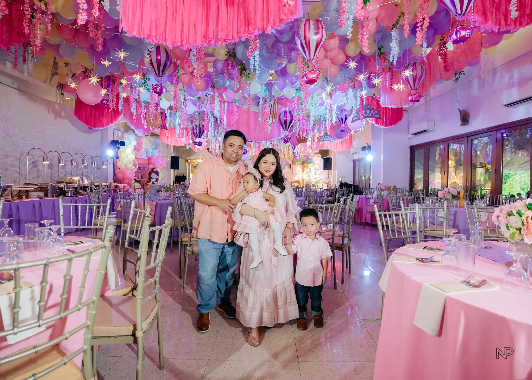 Pink princess castle birthday party with balloons, flowers and fairytale decorations
