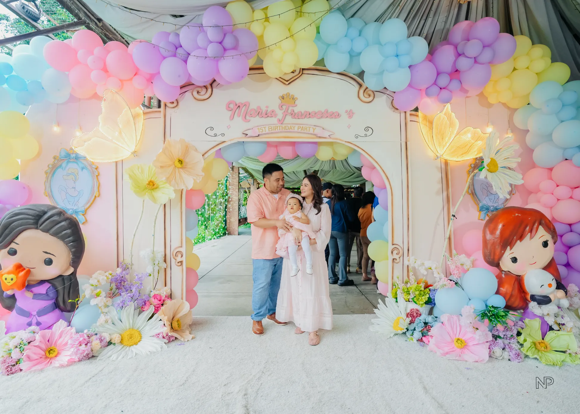 Princess birthday celebration with castle backdrop and pastel balloon decor